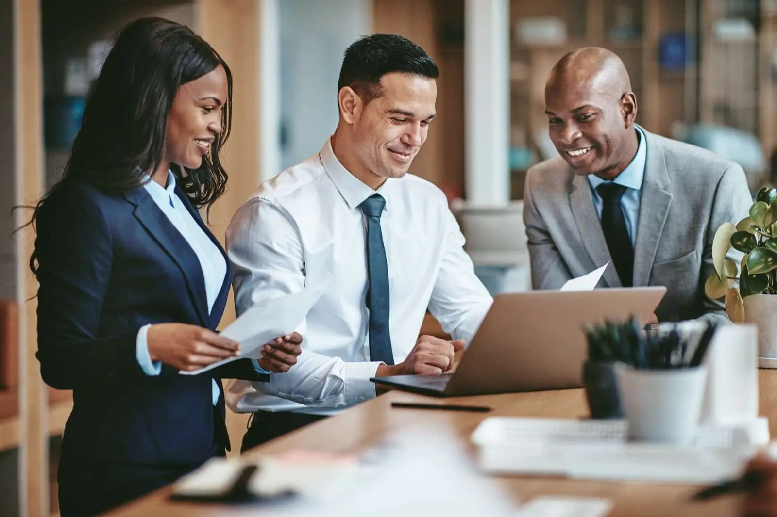 Advisors discussing international employment law compliance over a laptop