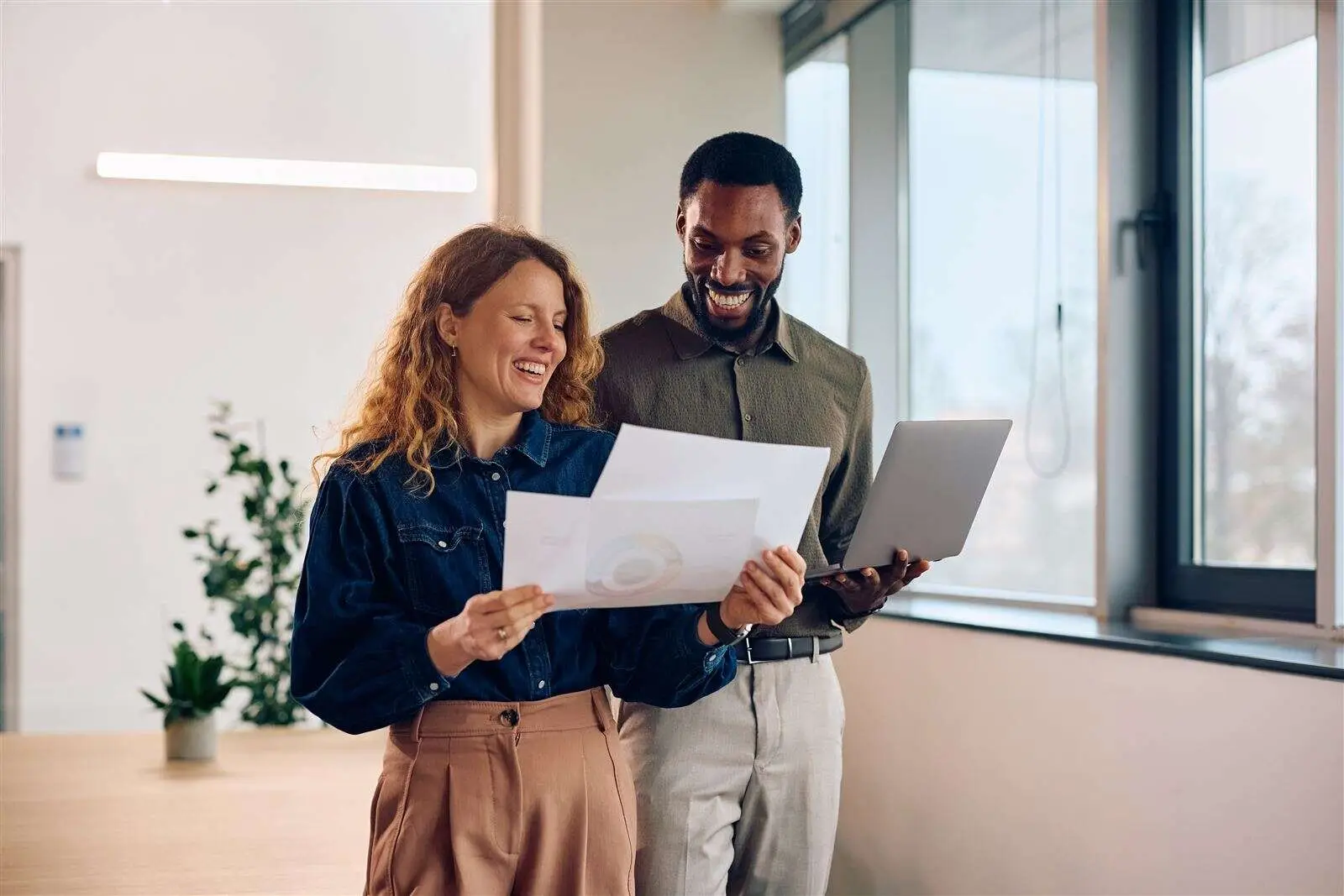 Colleagues reviewing financial documents together in a modern office