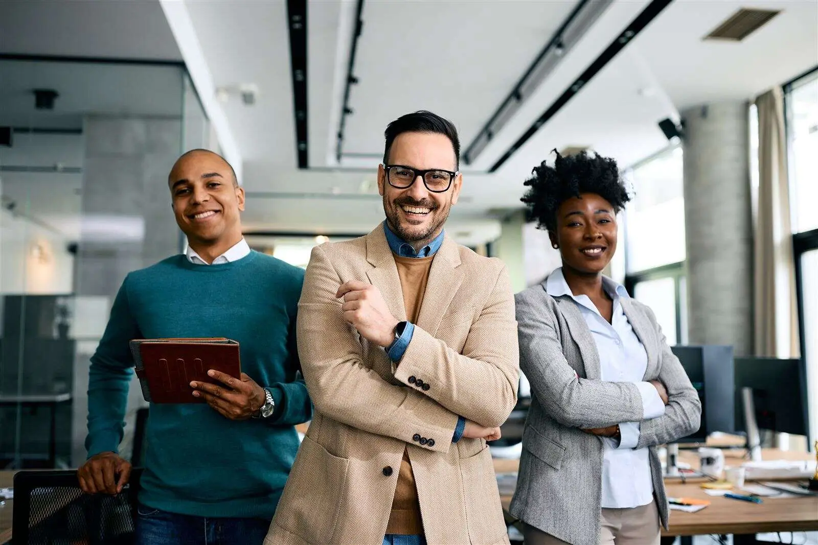 Colleagues standing together in a modern office space