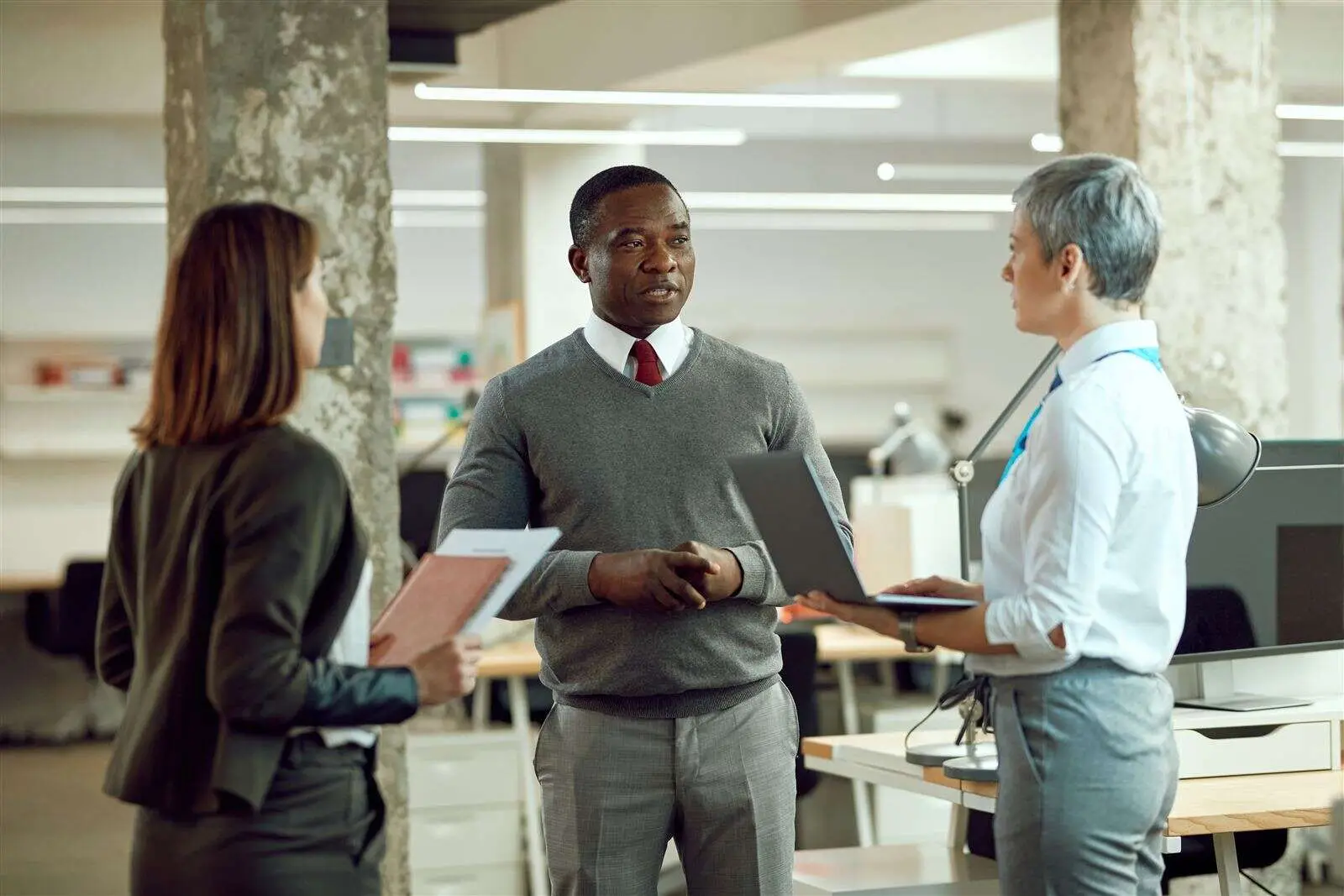 Colleagues in a meeting in a modern open-plan office